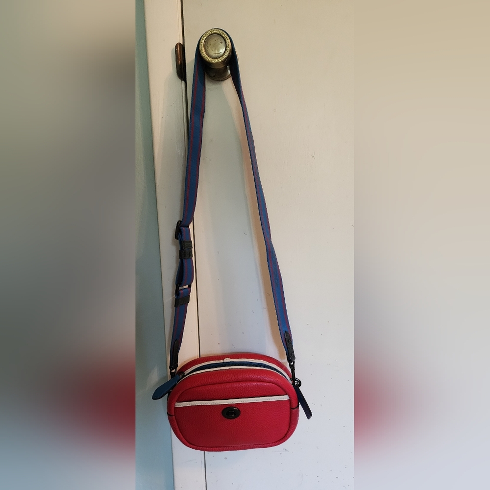 Coach camera bag, red with blue strap. Pocket on both sides. Zipper compartment